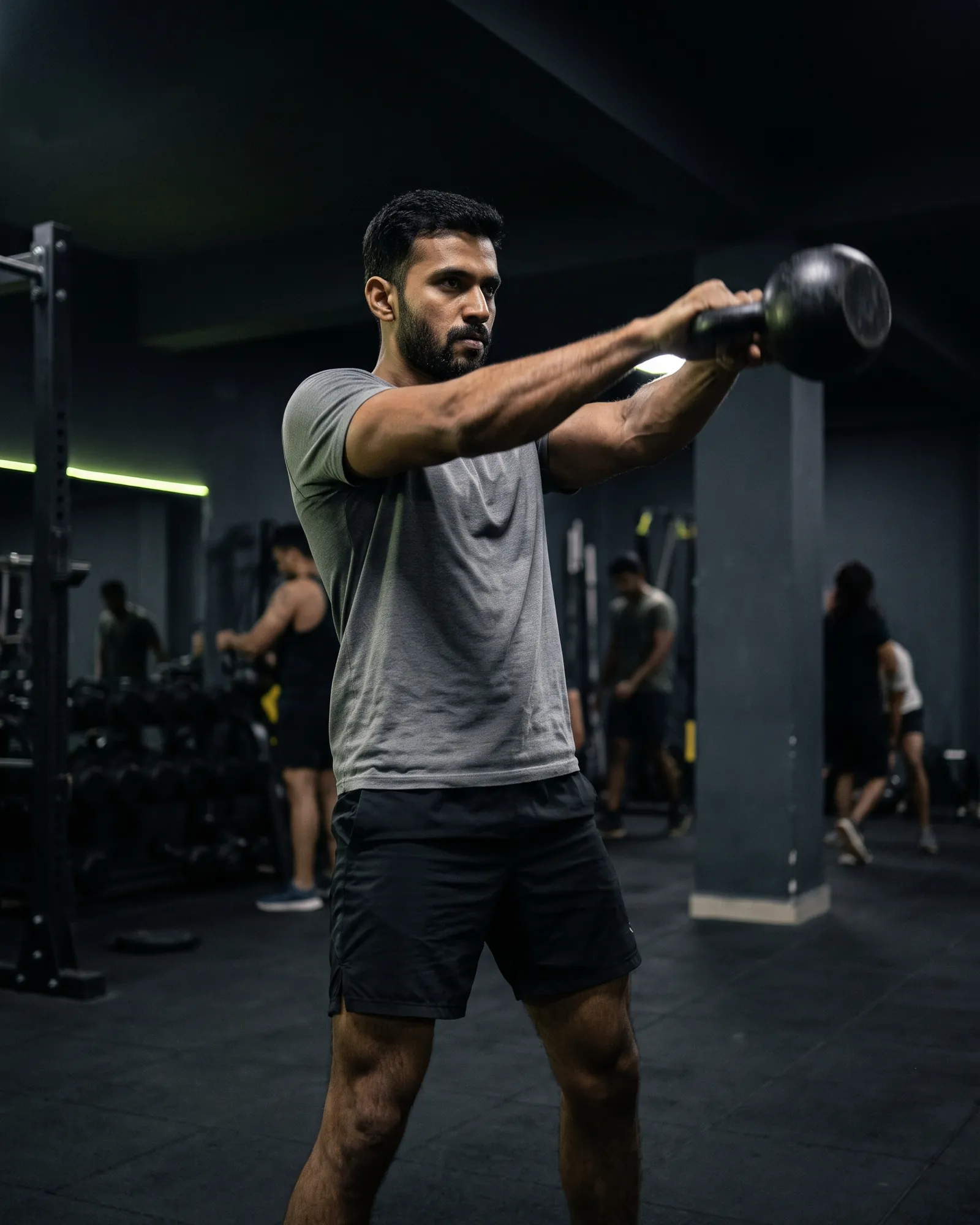 Man swinging a kettlebell during strength training