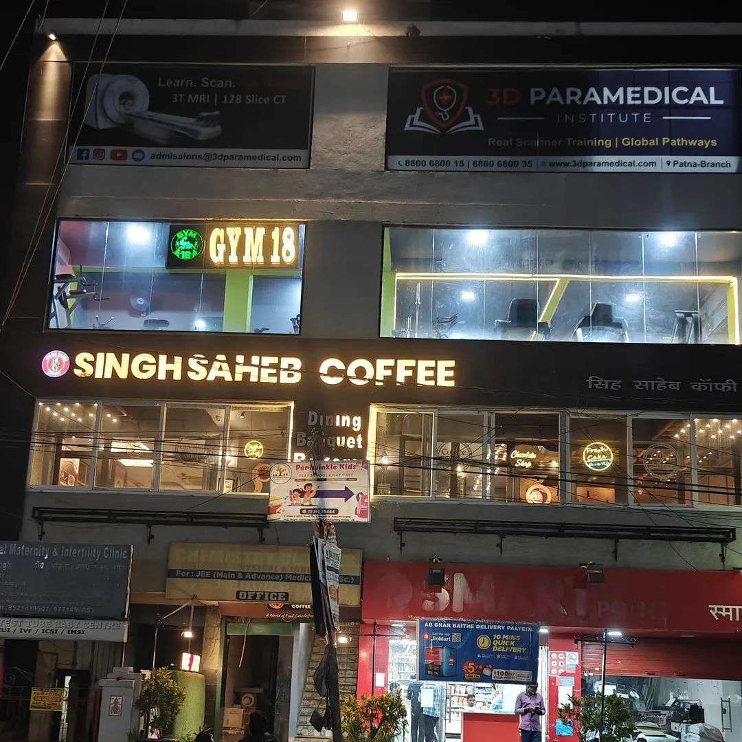 The Gym-18 sign on the building on Kanti Factory Road at night