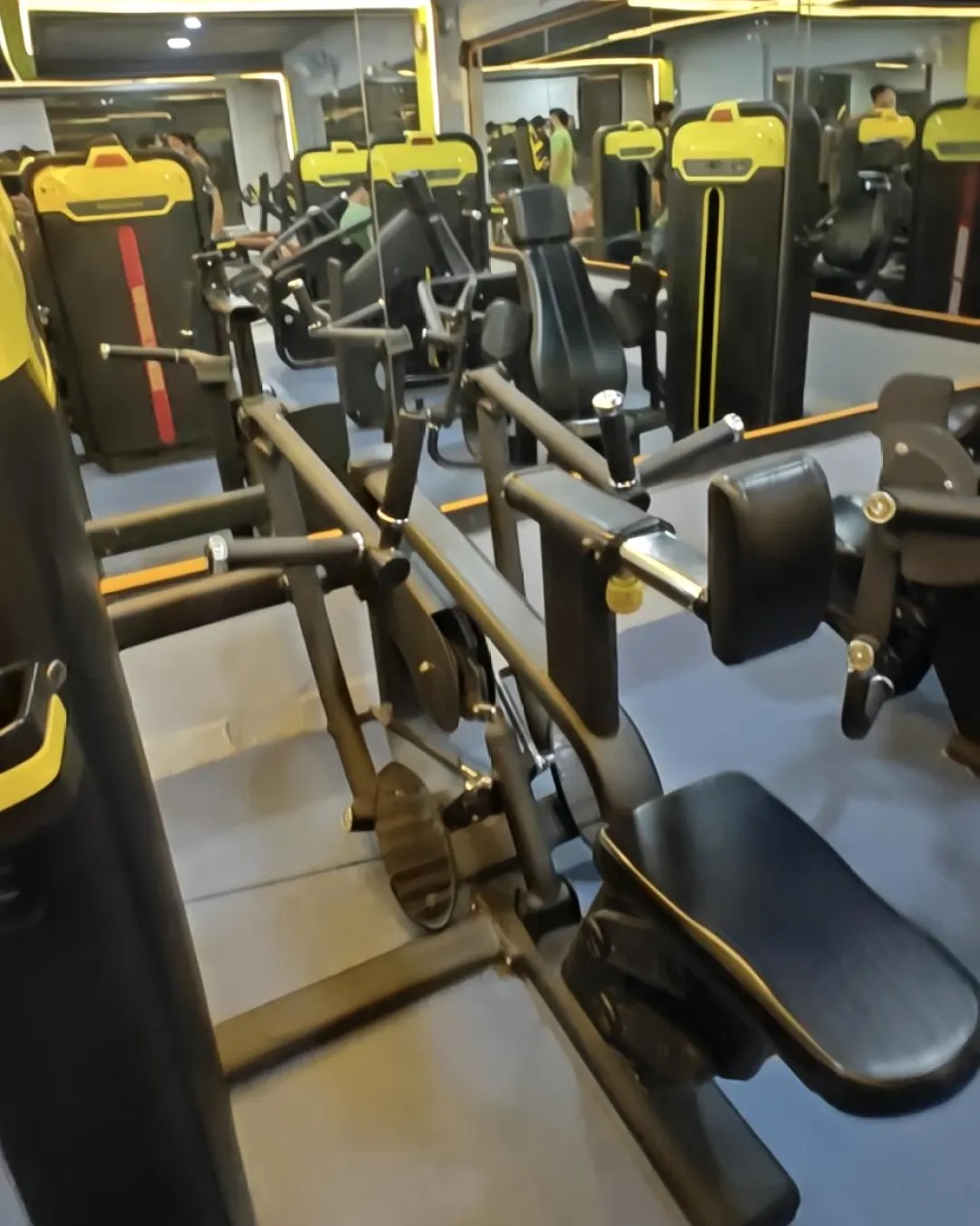 Row of new strength machines on the blue rubber floor at Gym-18
